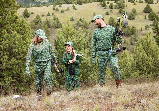 Family walking up hill in HECS clothing