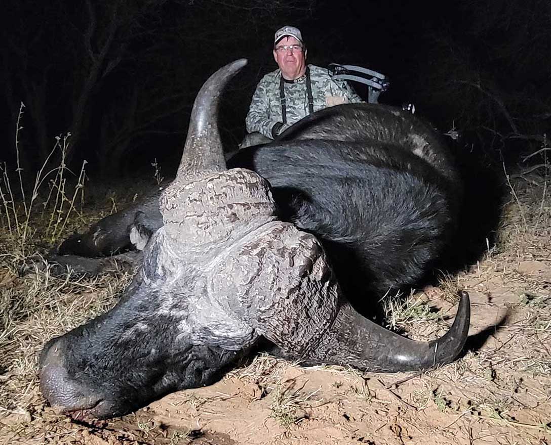 Hunter with water buffalo in Africa
